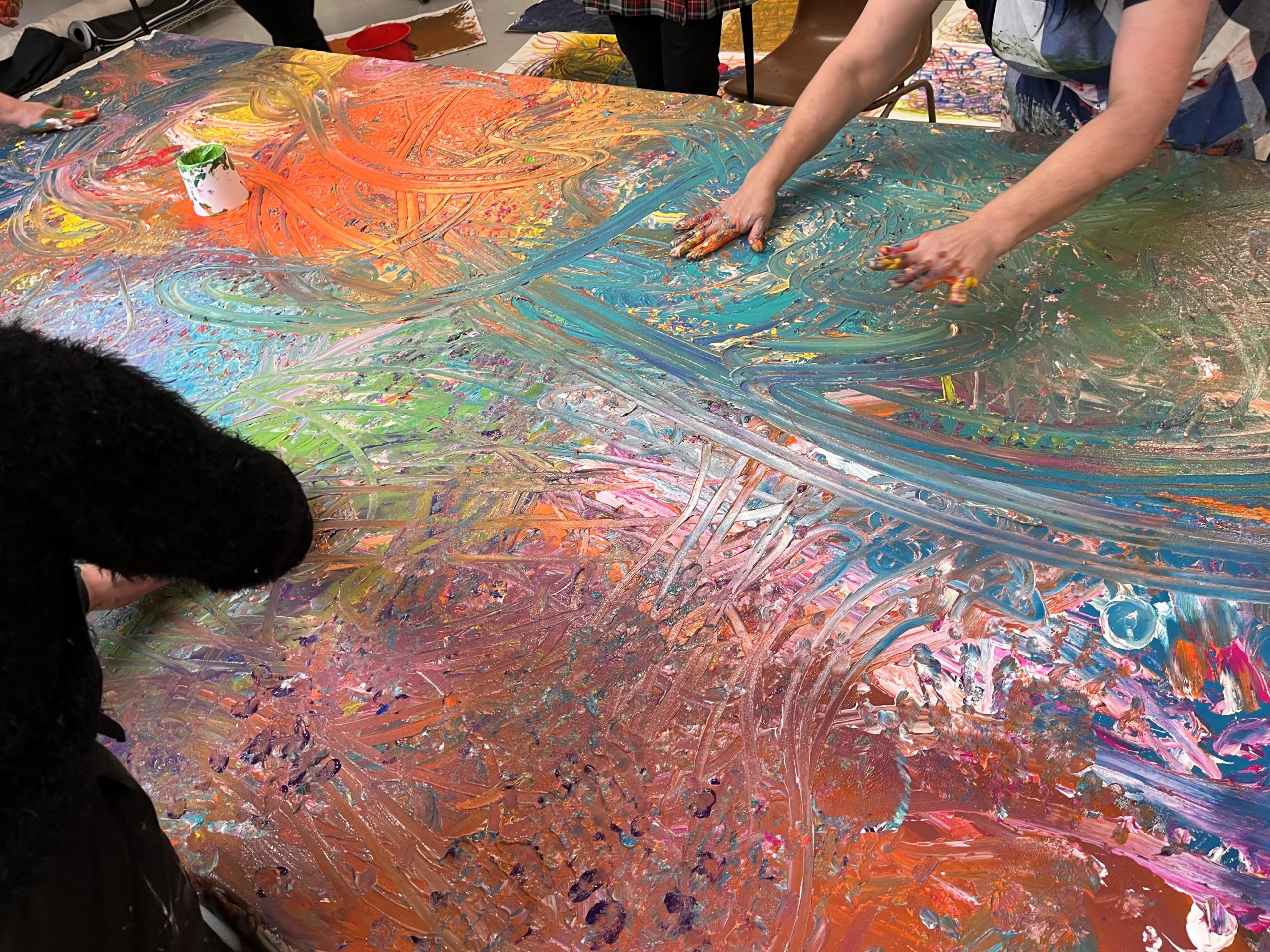 group painting Previous Art Therapy Workshop 2024, participants painting a large, group painting on canvas.