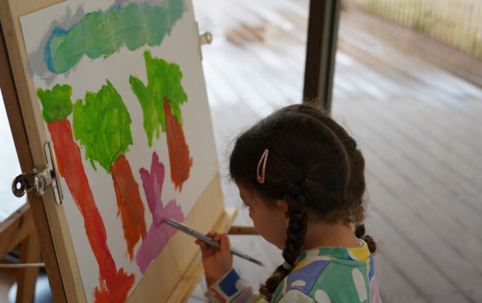 A child painting a landscape in a previous workshop