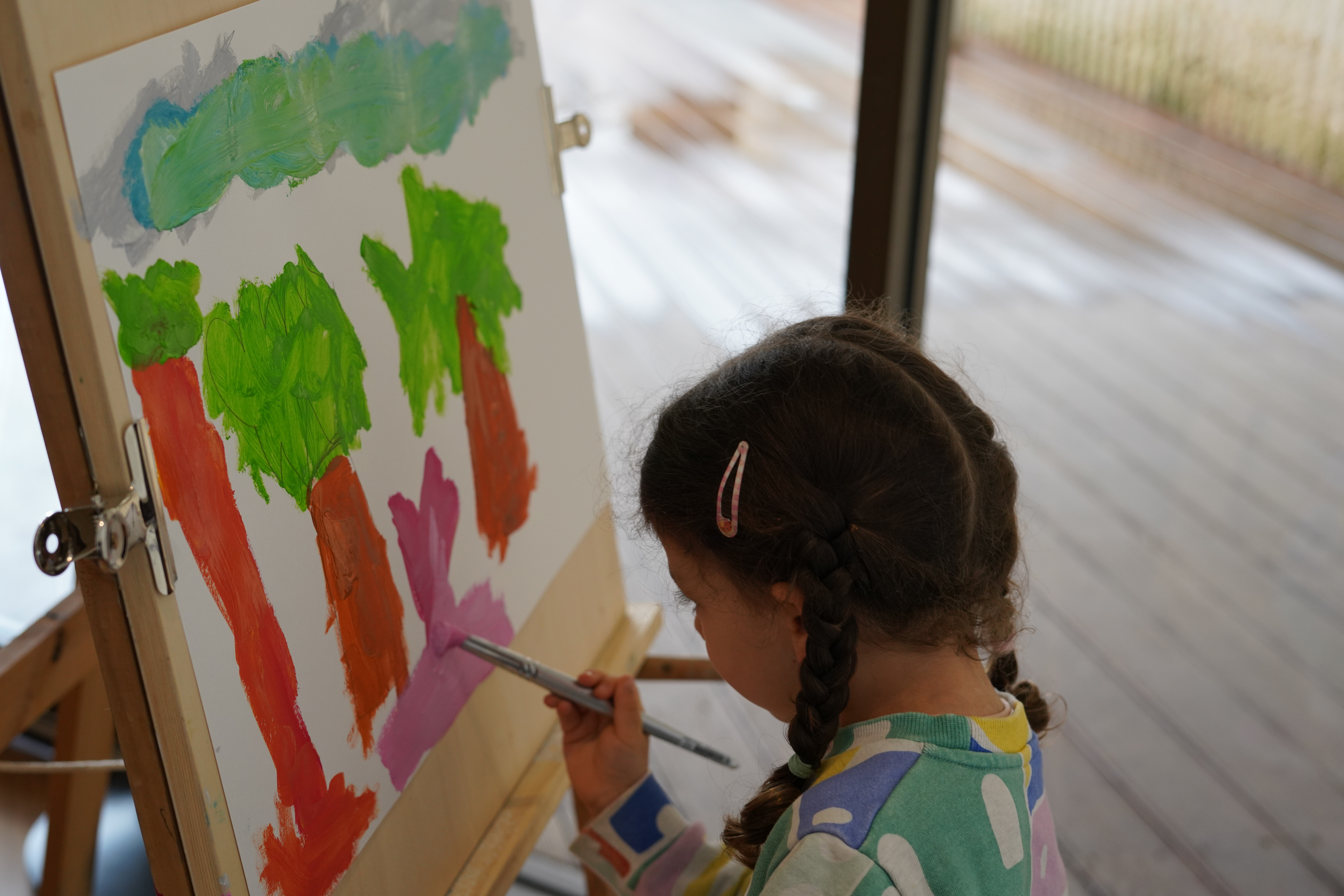 A child painting a landscape in a previous workshop